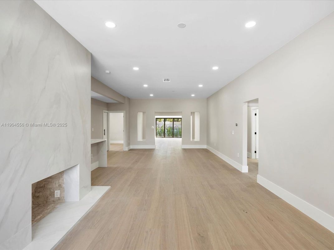 Empty room, Fireplace, Interior, Marble Walls, Recessed Lighting, Wood Texture Flooring