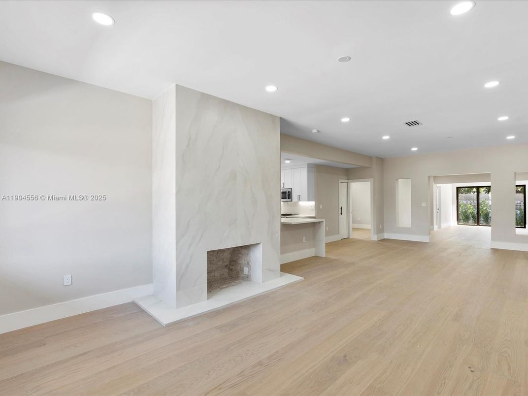 Empty room, Fireplace, Interior, Marble Walls, Recessed Lighting, Wood Texture Flooring