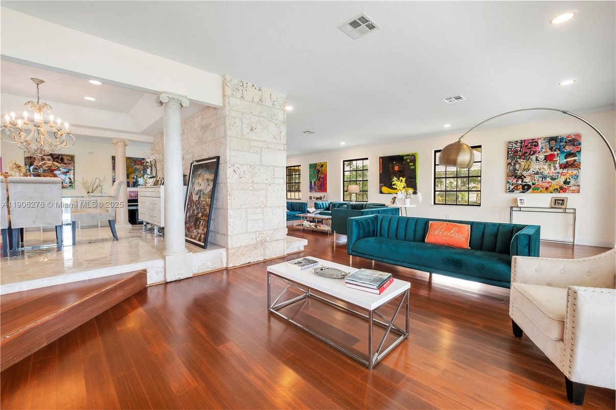 Chandelier, Fireplace, Interior, Living room, Recessed Lighting, Stone Walls, Wood Texture Flooring