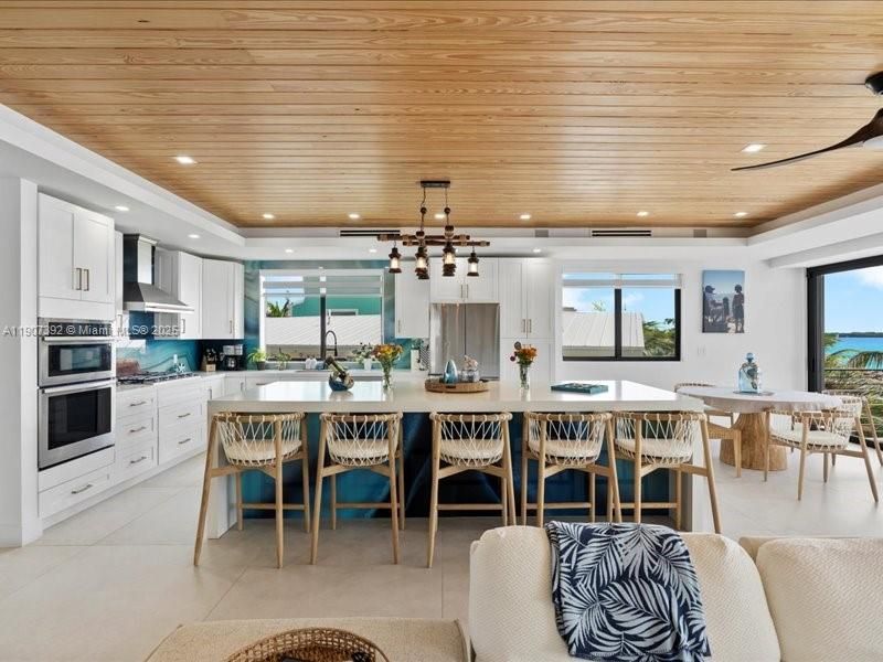 Dining room, Interior, Kitchen, Pendant Lights, Recessed Lighting, Stainless Steel Appliances, Water, Wooden Ceilings