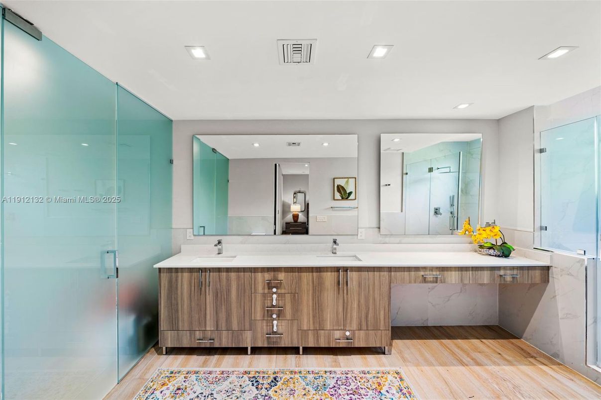 Bathroom, Dual Sink Vanities, Glass Shower, Interior, Marble Walls, Recessed Lighting, Wood Texture Flooring