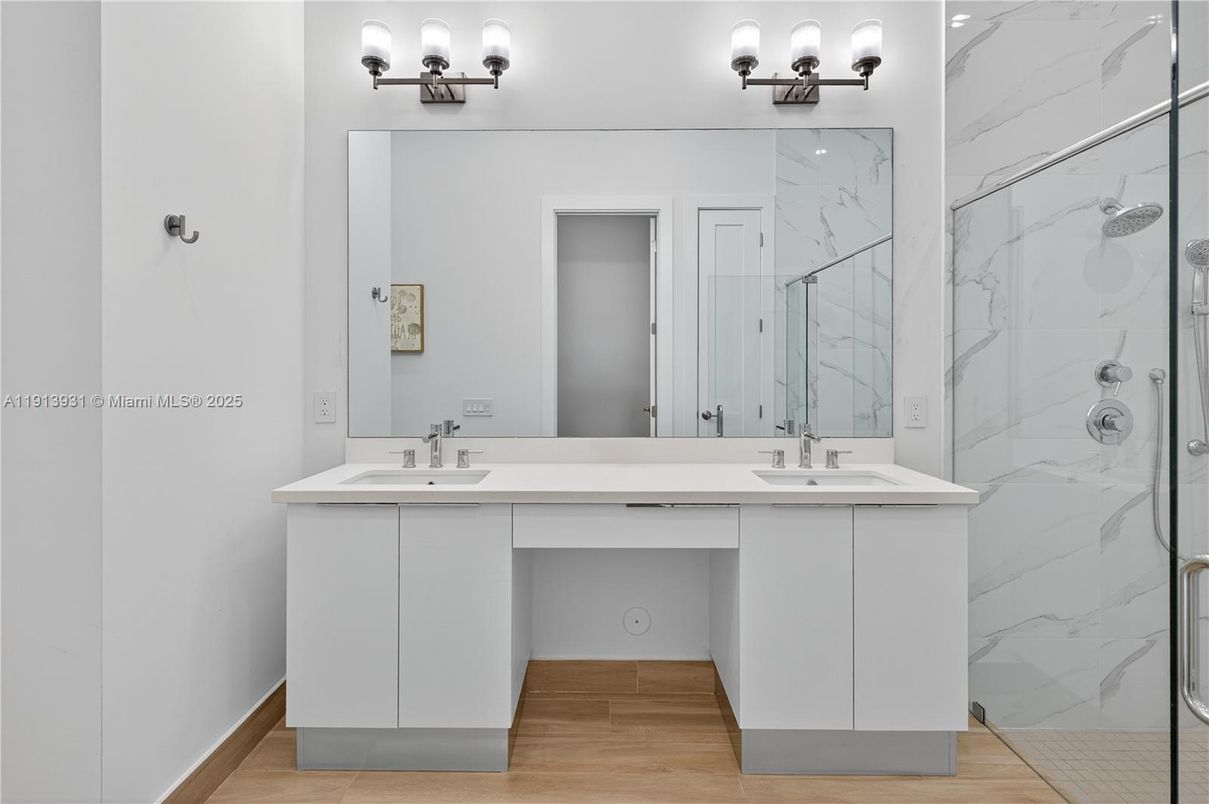 Bathroom, Dual Sink Vanities, Glass Shower, Interior, Marble Walls, Wood Texture Flooring