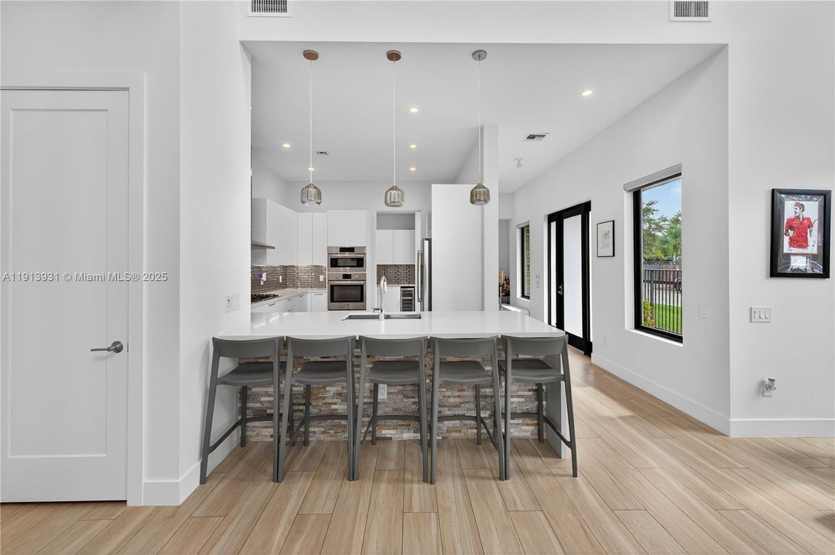 Dining room, Interior, Kitchen, Pendant Lights, Recessed Lighting, Stainless Steel Appliances, Wood Texture Flooring