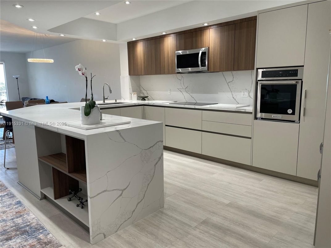 Interior, Kitchen, Marble Walls, Pendant Lights, Recessed Lighting, Stainless Steel Appliances, Wood Texture Flooring