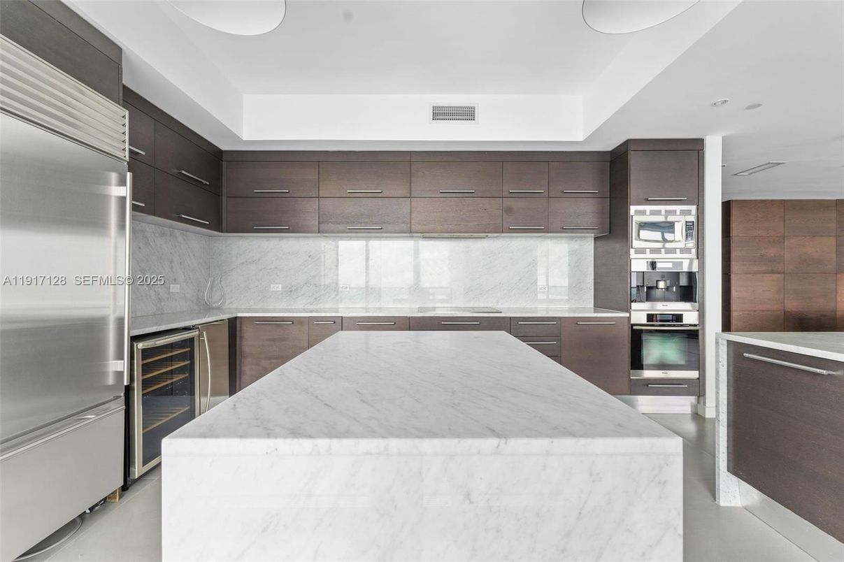 Interior, Kitchen, Marble Walls, Recessed Lighting, Stainless Steel Appliances