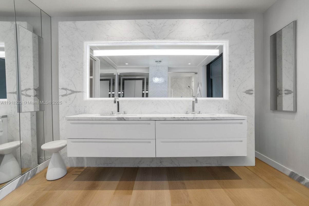 Bathroom, Dual Sink Vanities, Interior, Marble Walls, Recessed Lighting, Wood Texture Flooring