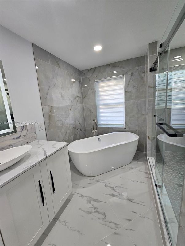 Bathroom, Dual Sink Vanities, Free Standing Baths, Glass Shower, Interior, Marble, Marble Walls, Recessed Lighting