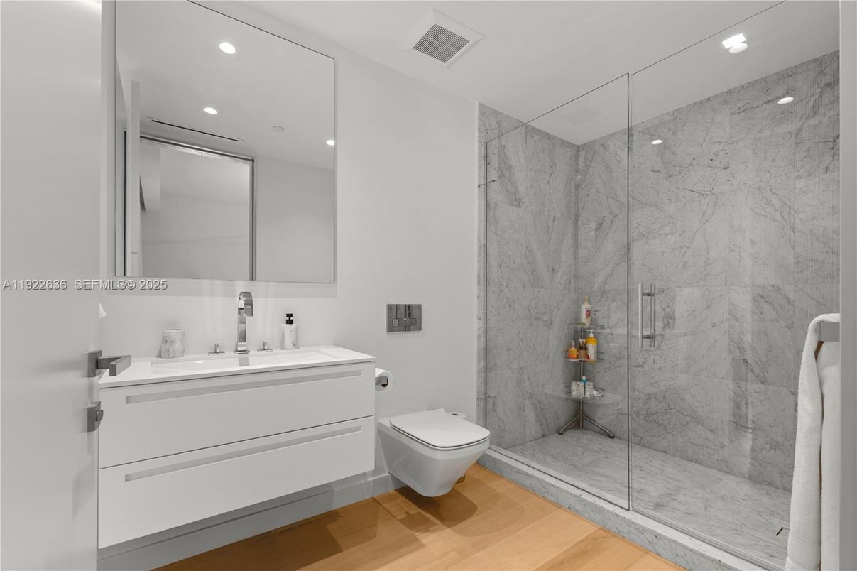 Bathroom, Glass Shower, Interior, Marble Walls, Recessed Lighting, Wood Texture Flooring