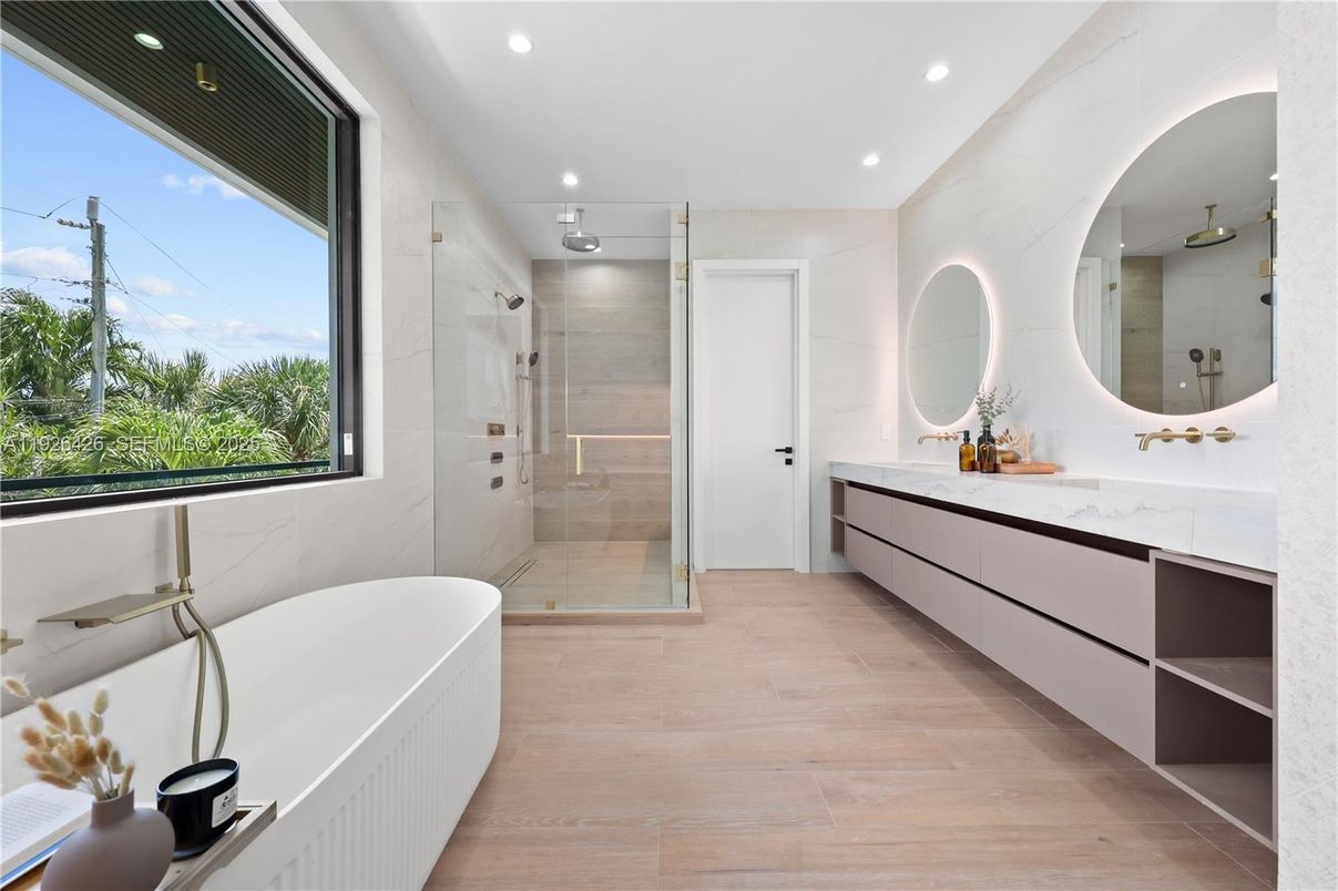 Bathroom, Dual Sink Vanities, Free Standing Baths, Glass Shower, Interior, Marble Walls, Recessed Lighting, Wood Texture Flooring