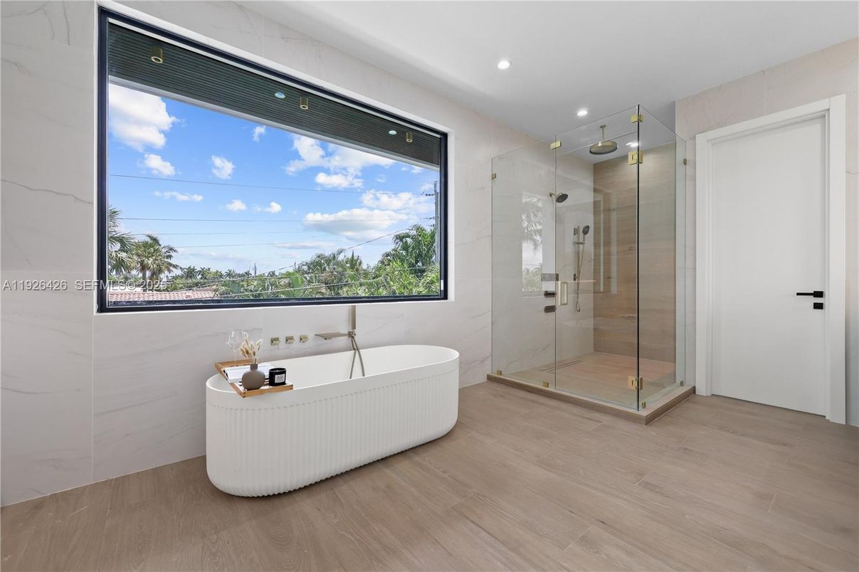 Bathroom, Free Standing Baths, Glass Shower, Interior, Marble Walls, Recessed Lighting, Wood Texture Flooring