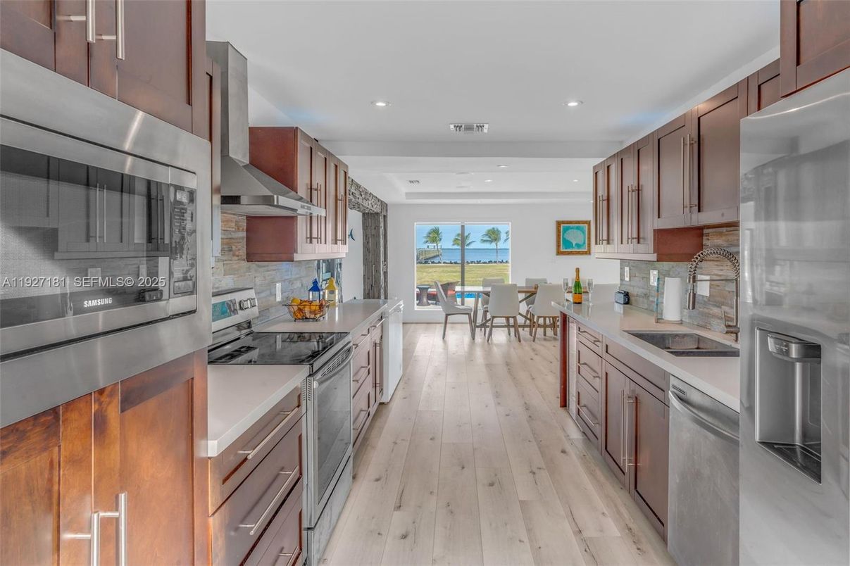 Dining room, Interior, Kitchen, Recessed Lighting, Stainless Steel Appliances, Water, Wood Texture Flooring