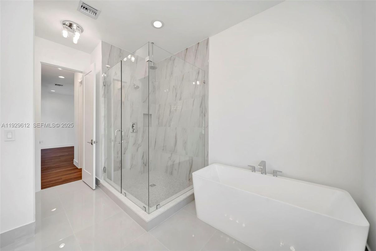 Bathroom, Free Standing Baths, Glass Shower, Interior, Marble Walls, Recessed Lighting, Wood Texture Flooring