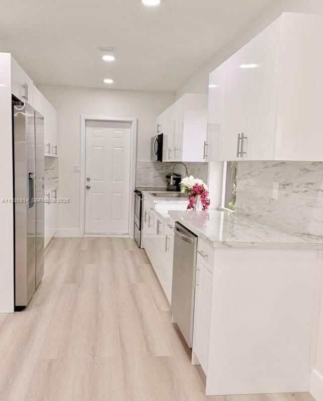 Interior, Kitchen, Marble Walls, Recessed Lighting, Stainless Steel Appliances, Wood Texture Flooring