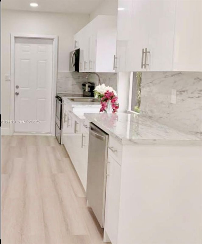 Interior, Kitchen, Marble Walls, Recessed Lighting, Stainless Steel Appliances, Wood Texture Flooring