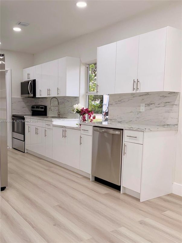 Interior, Kitchen, Marble Walls, Recessed Lighting, Stainless Steel Appliances, Wood Texture Flooring