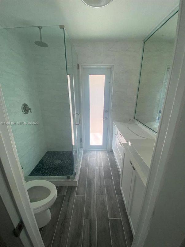 Bathroom, Glass Shower, Interior, Marble Walls, Wood Texture Flooring