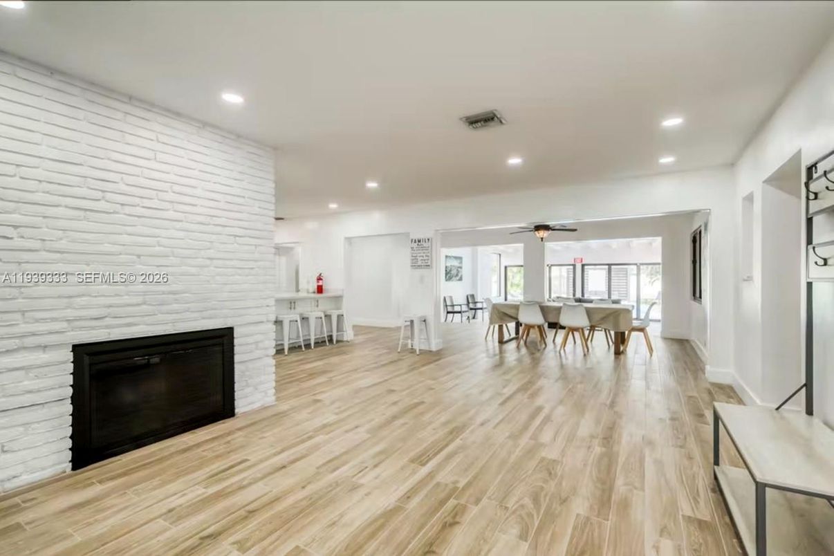 Dining room, Fireplace, Interior, Recessed Lighting, Stone Walls, Wood Texture Flooring