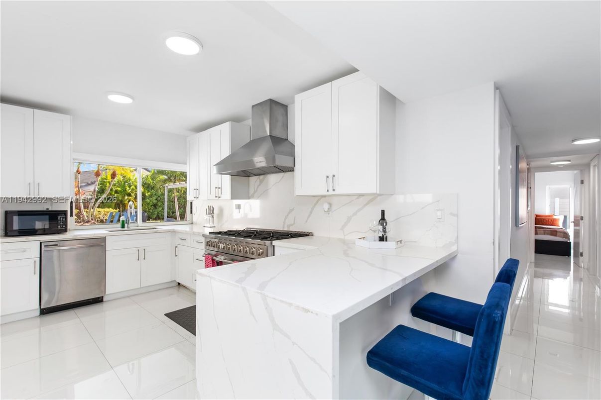 Interior, Kitchen, Marble Walls, Recessed Lighting, Stainless Steel Appliances