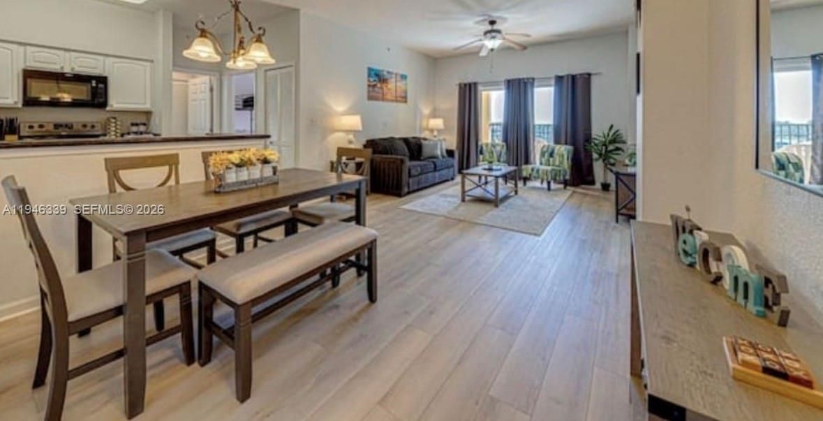 Chandelier, Dining room, Interior, Kitchen, Living room, Pendant Lights, Stainless Steel Appliances, Wood Texture Flooring