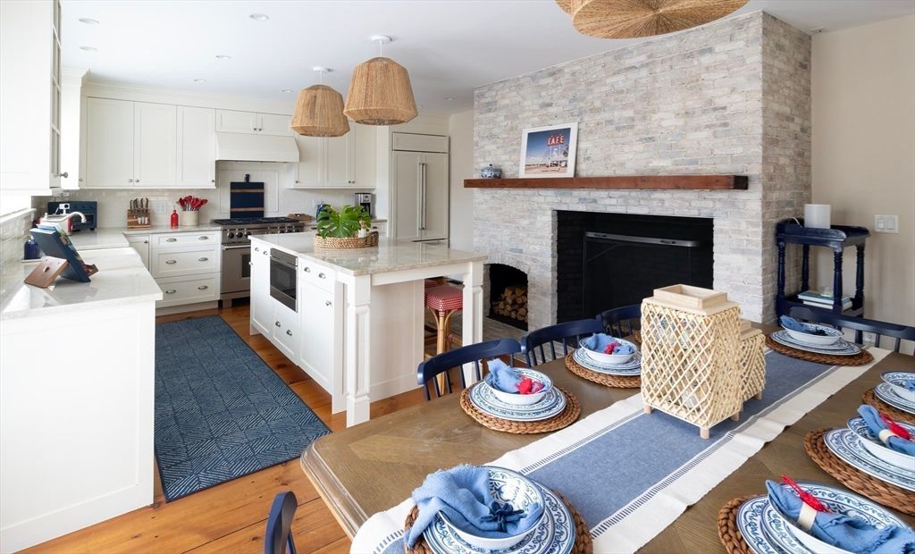 Dining room, Fireplace, Interior, Kitchen, Pendant Lights, Recessed Lighting, Stainless Steel Appliances, Stone Walls, Wood Texture Flooring