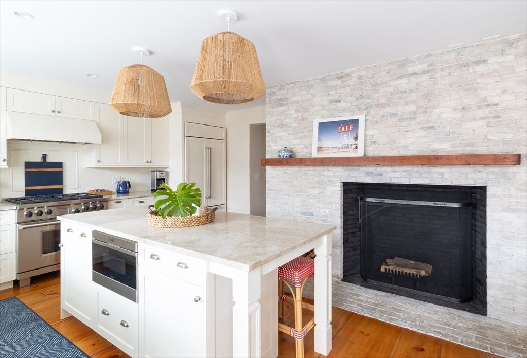 Fireplace, Interior, Kitchen, Pendant Lights, Recessed Lighting, Stainless Steel Appliances, Stone Walls, Wood Texture Flooring