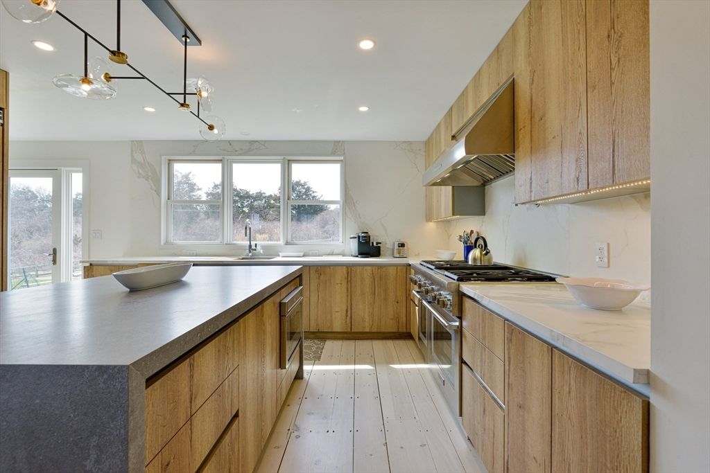 Interior, Kitchen, Marble Walls, Pendant Lights, Recessed Lighting, Stainless Steel Appliances, Wood Texture Flooring