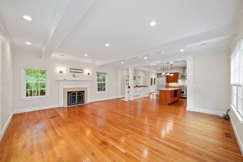 Empty room, Fireplace, Interior, Kitchen, Pendant Lights, Recessed Lighting, Stainless Steel Appliances, Wood Texture Flooring