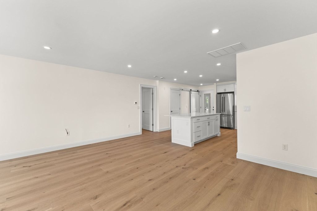 Empty room, Interior, Kitchen, Recessed Lighting, Stainless Steel Appliances, Wood Texture Flooring