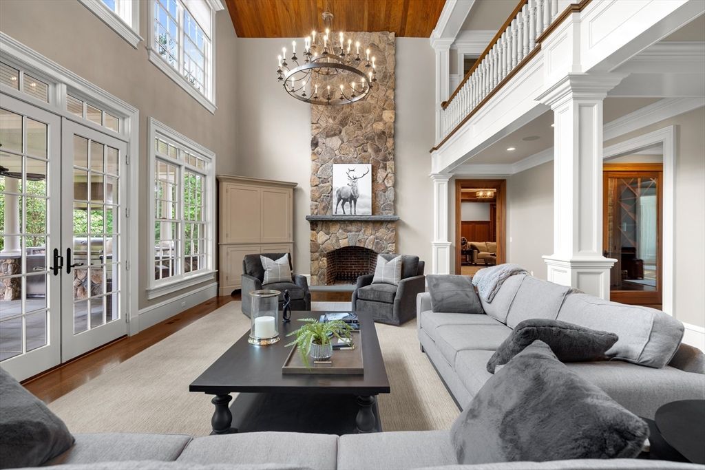 Chandelier, Fireplace, Interior, Living room, Recessed Lighting, Stone Walls, Wood Texture Flooring