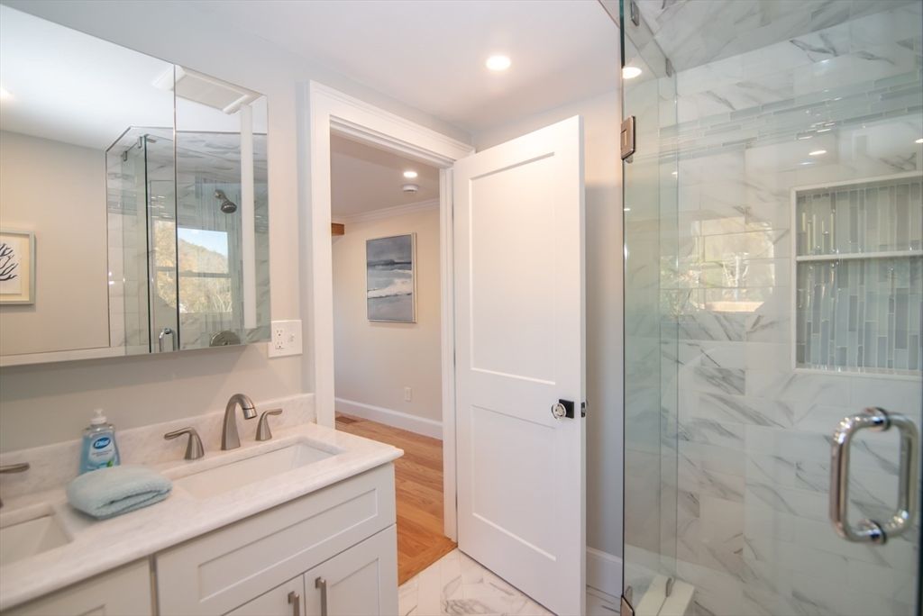 Bathroom, Dual Sink Vanities, Glass Shower, Interior, Marble, Marble Walls, Recessed Lighting, Wood Texture Flooring
