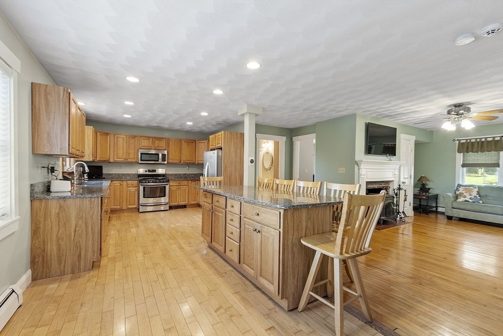 Fireplace, Interior, Kitchen, Recessed Lighting, Stainless Steel Appliances, Wood Texture Flooring