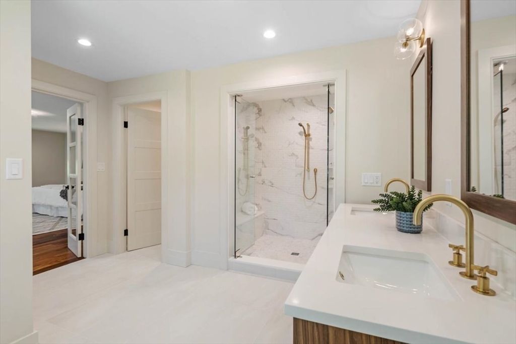 Bathroom, Dual Sink Vanities, Glass Shower, Interior, Marble Walls, Recessed Lighting, Wood Texture Flooring