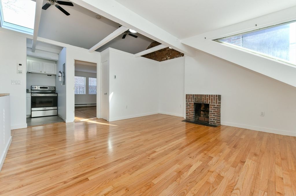 Empty room, Fireplace, Interior, Kitchen, Stainless Steel Appliances, Wood Texture Flooring