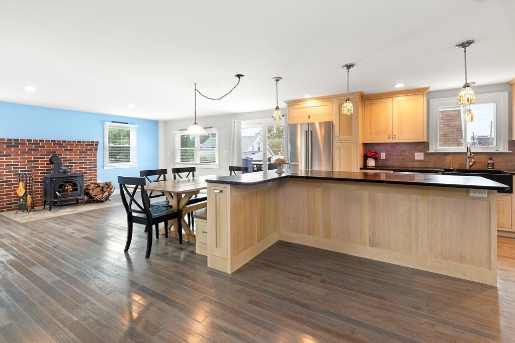 Dining room, Fireplace, Interior, Kitchen, Pendant Lights, Recessed Lighting, Stainless Steel Appliances, Stone Walls, Wood Texture Flooring
