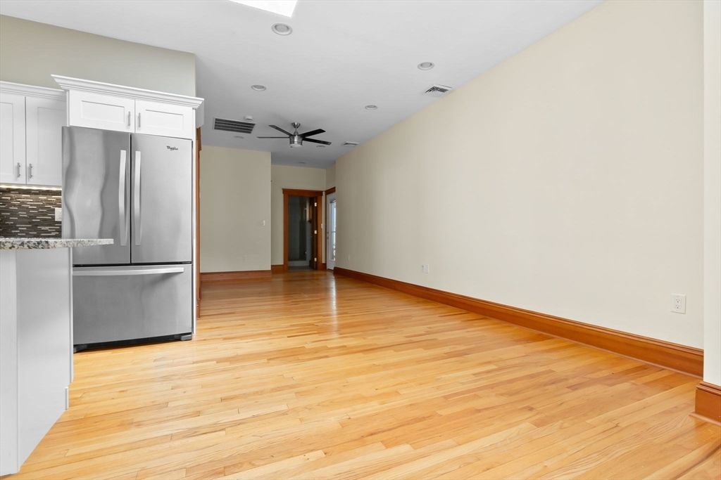Empty room, Interior, Kitchen, Recessed Lighting, Stainless Steel Appliances, Wood Texture Flooring