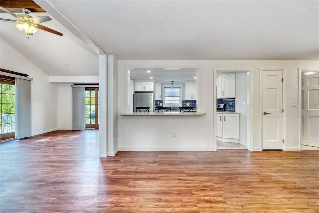 Empty room, Interior, Kitchen, Recessed Lighting, Stainless Steel Appliances, Wood Texture Flooring