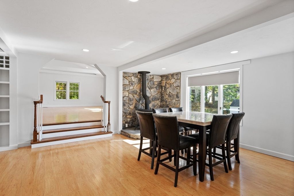 Dining room, Fireplace, Interior, Recessed Lighting, Stone Walls, Wood Texture Flooring