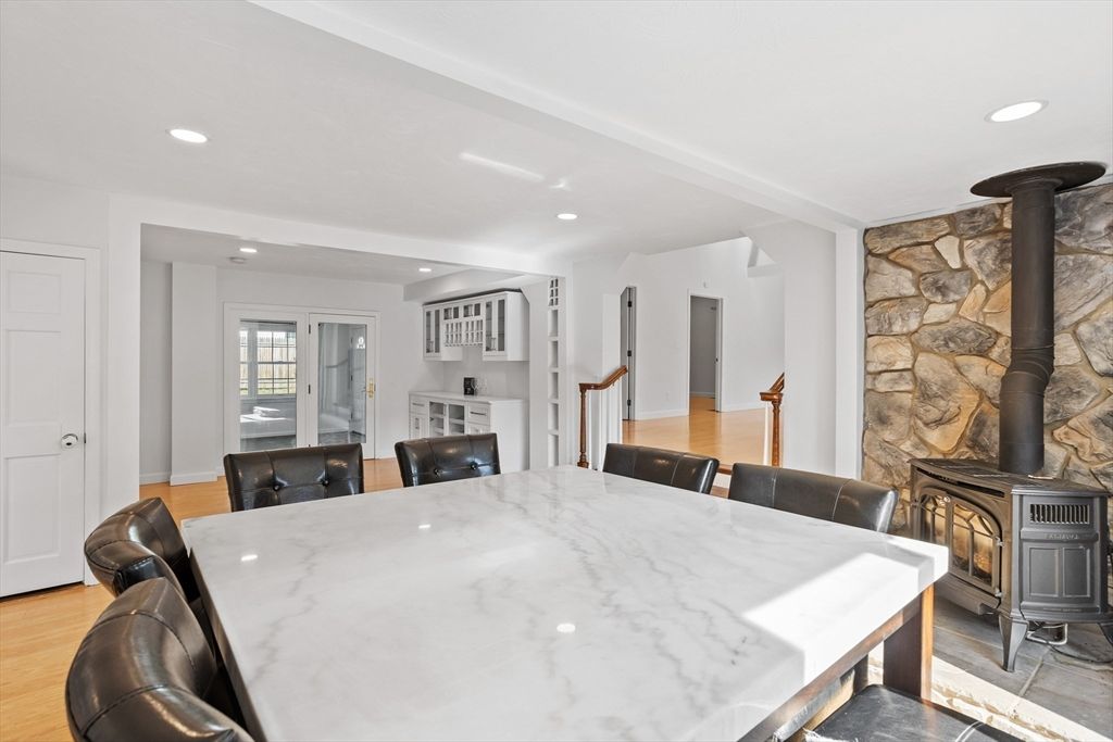 Dining room, Fireplace, Interior, Recessed Lighting, Stone Walls, Wood Texture Flooring