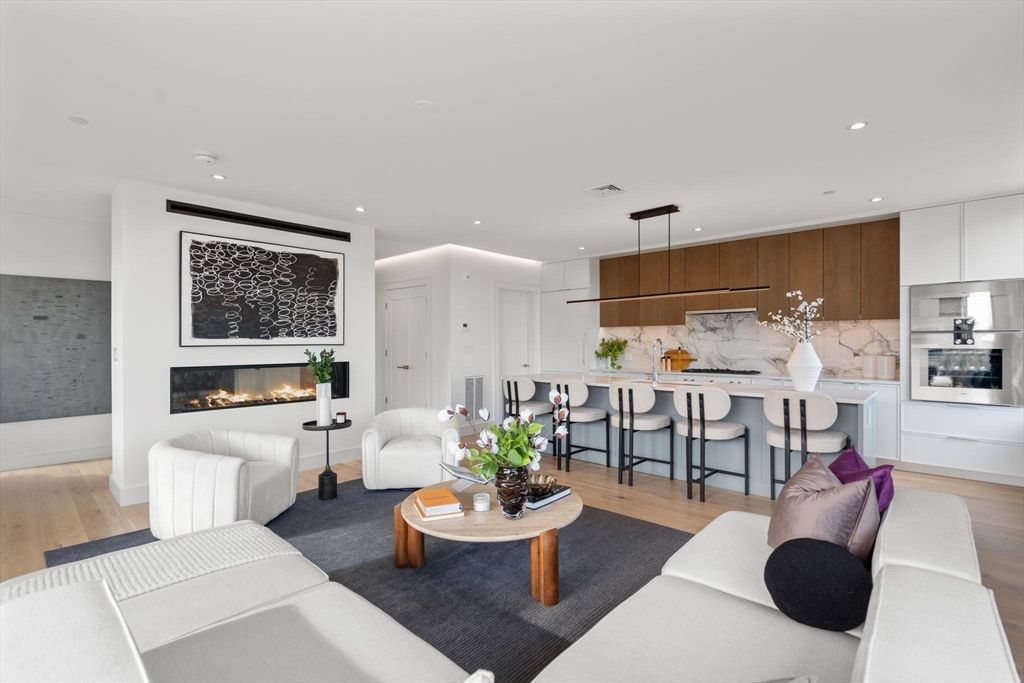 Fireplace, Interior, Kitchen, Living room, Marble Walls, Pendant Lights, Recessed Lighting, Stainless Steel Appliances, Wood Texture Flooring