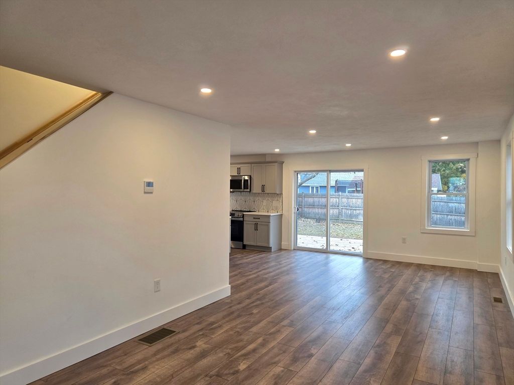 Empty room, Interior, Kitchen, Recessed Lighting, Stainless Steel Appliances, Wood Texture Flooring