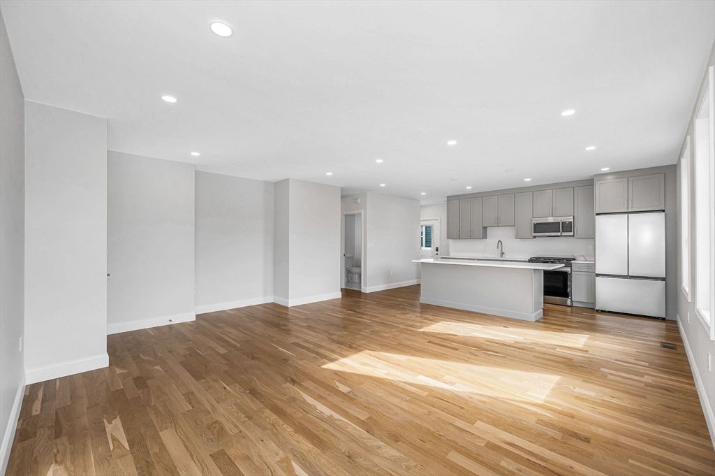 Empty room, Interior, Kitchen, Recessed Lighting, Stainless Steel Appliances, Wood Texture Flooring
