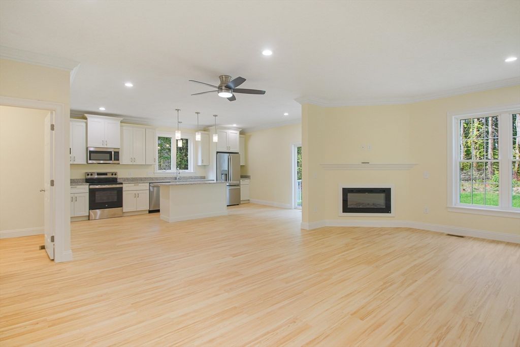 Empty room, Fireplace, Interior, Kitchen, Pendant Lights, Recessed Lighting, Stainless Steel Appliances, Wood Texture Flooring