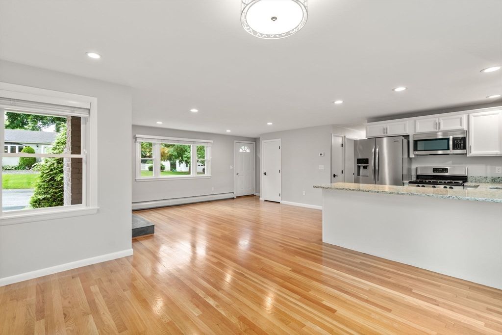 Empty room, Interior, Kitchen, Recessed Lighting, Stainless Steel Appliances, Wood Texture Flooring