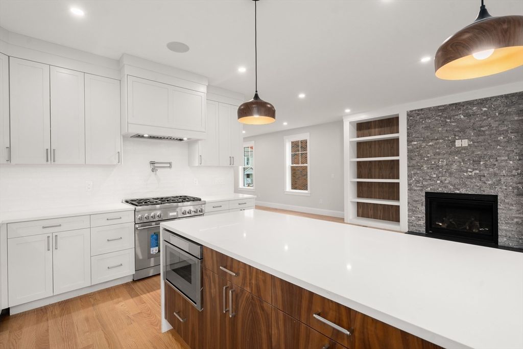 Fireplace, Interior, Kitchen, Pendant Lights, Recessed Lighting, Stainless Steel Appliances, Wood Texture Flooring