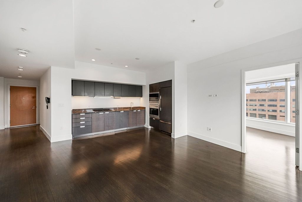 Empty room, Interior, Kitchen, Recessed Lighting, Stainless Steel Appliances, Wood Texture Flooring
