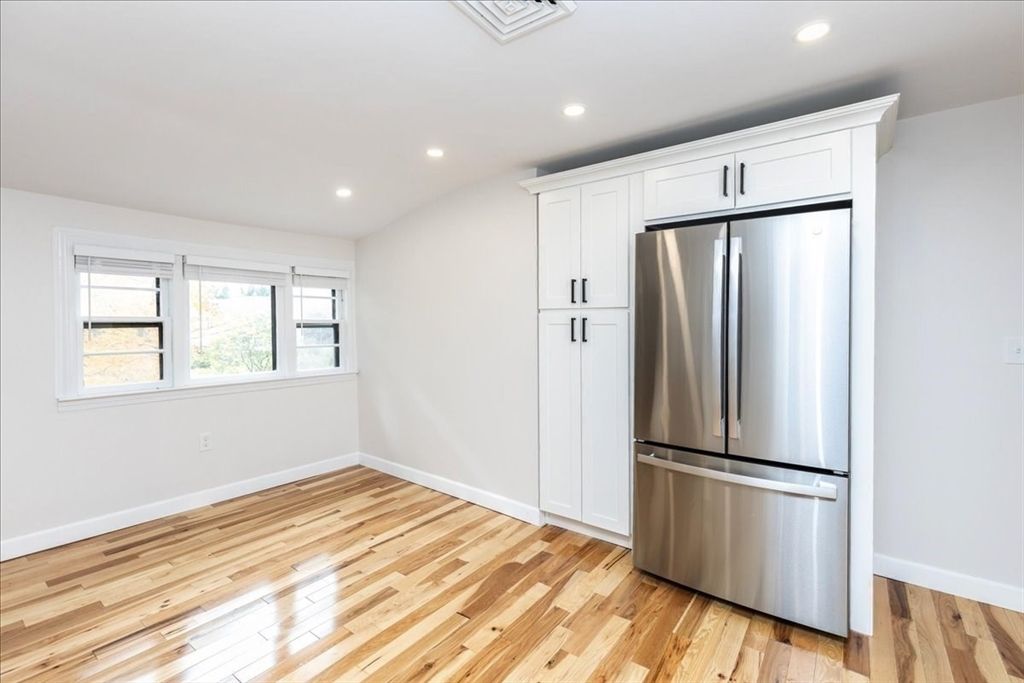 Empty room, Interior, Kitchen, Recessed Lighting, Stainless Steel Appliances, Wood Texture Flooring