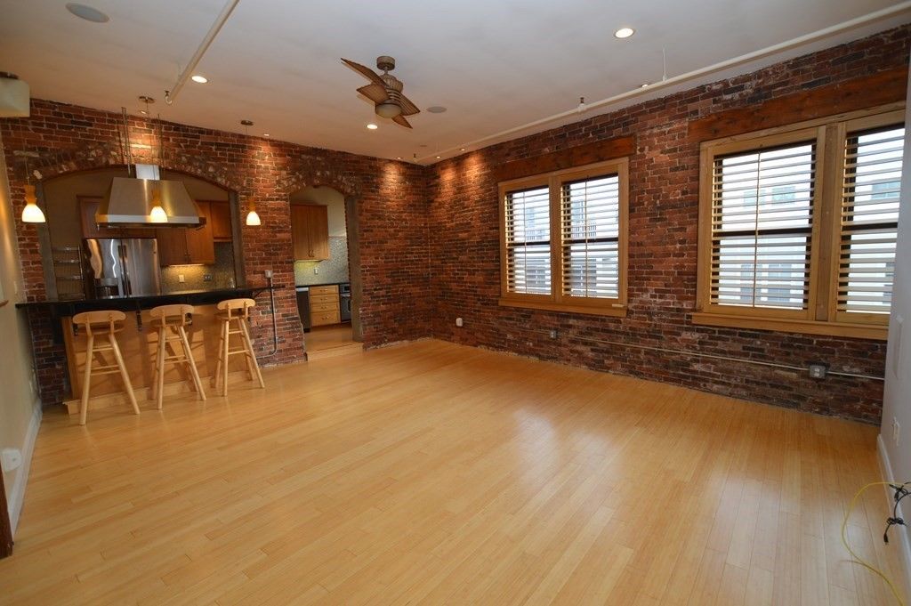 Empty room, Interior, Kitchen, Pendant Lights, Recessed Lighting, Stainless Steel Appliances, Stone Walls, Wood Texture Flooring