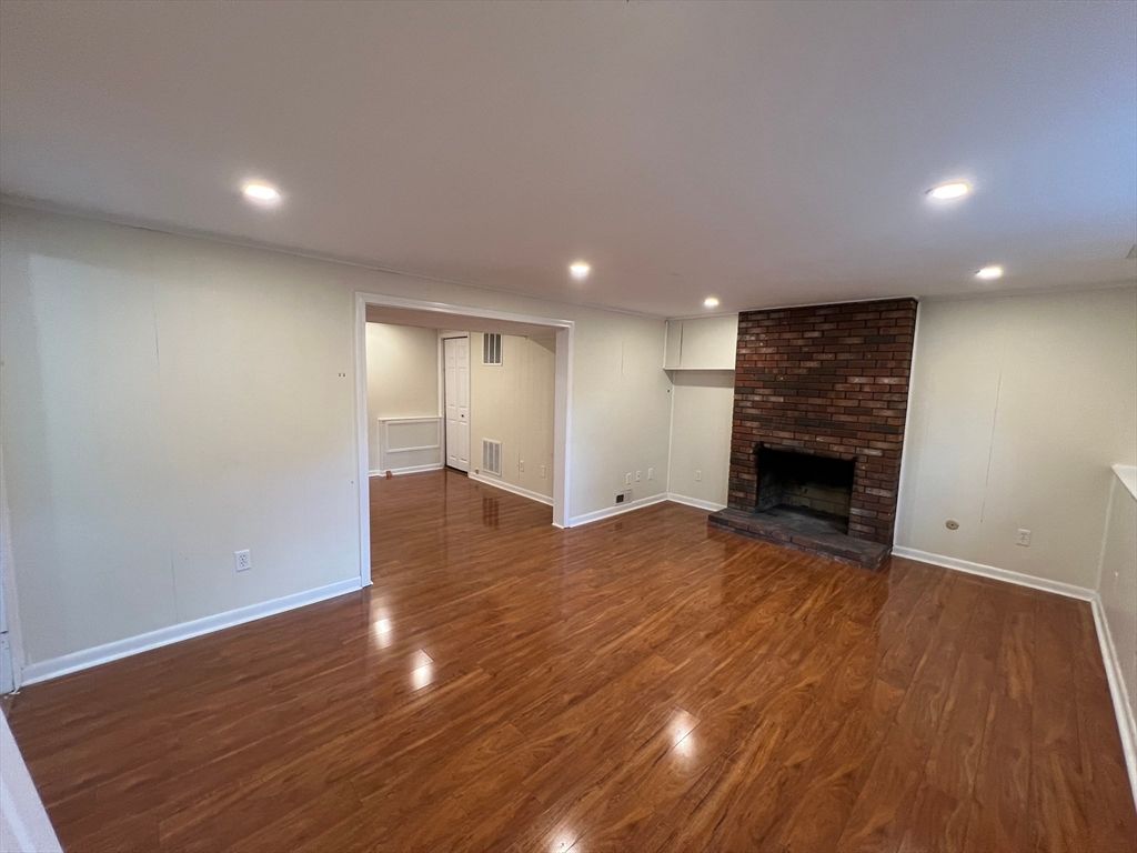 Empty room, Fireplace, Interior, Recessed Lighting, Stone Walls, Wood Texture Flooring