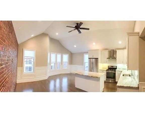 Empty room, Interior, Kitchen, Recessed Lighting, Stainless Steel Appliances, Stone Walls, Wood Texture Flooring