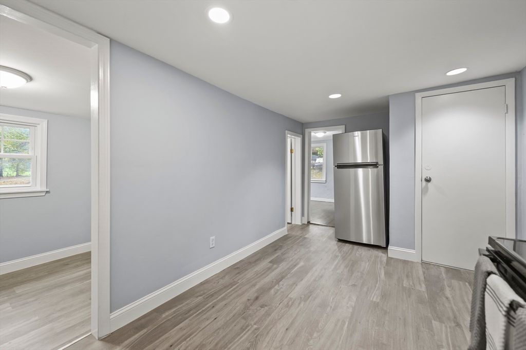 Empty room, Interior, Kitchen, Recessed Lighting, Stainless Steel Appliances, Wood Texture Flooring